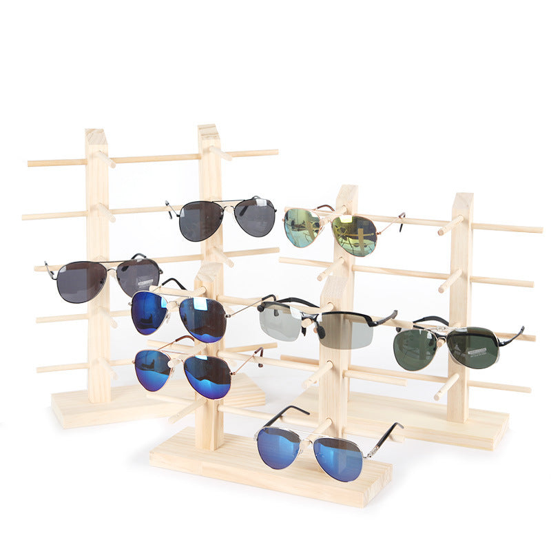 Stylish wood stand holding sunglasses
