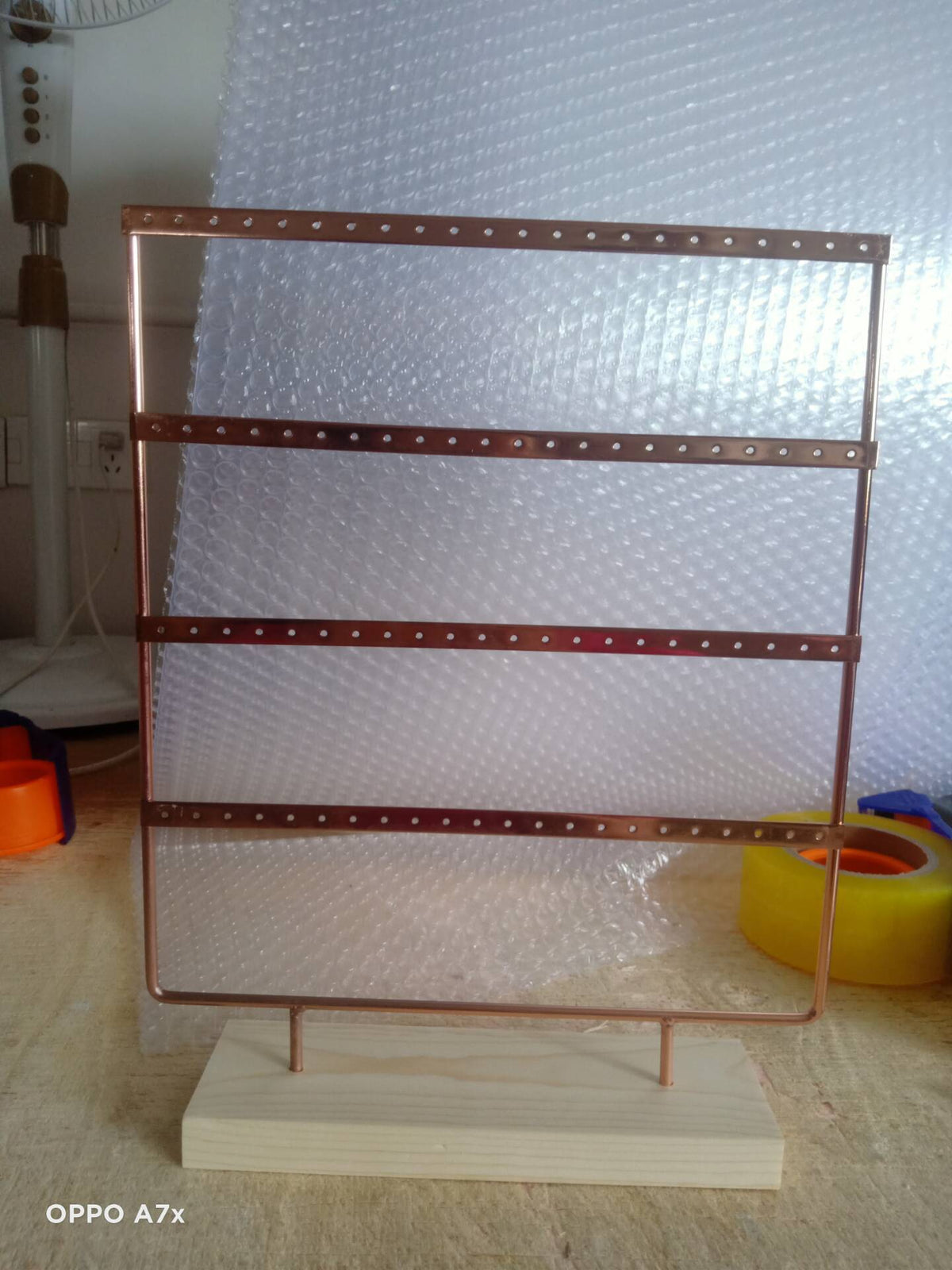 Close-up of Metal Earring Holder with Wooden Base - Image 2