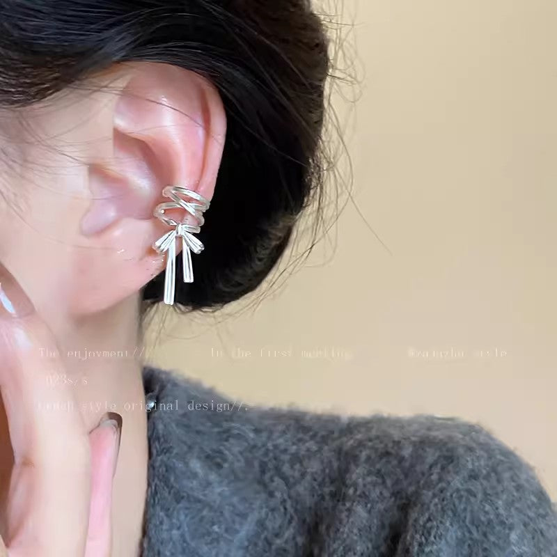 Close up of no piercing ear cuff with ribbon design