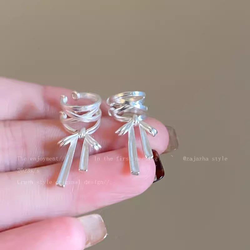 Fashionable ear cuffs displayed on white background