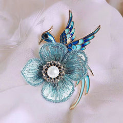 Handmade floral brooch displayed on fabric