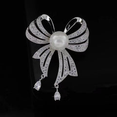 Image of stylish rhinestone brooch with pearl and ribbon design
