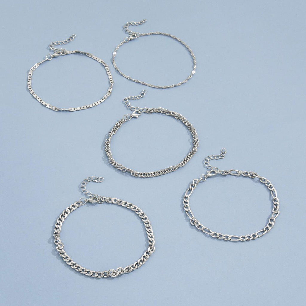 Stacked view of multiple snake chain anklets
