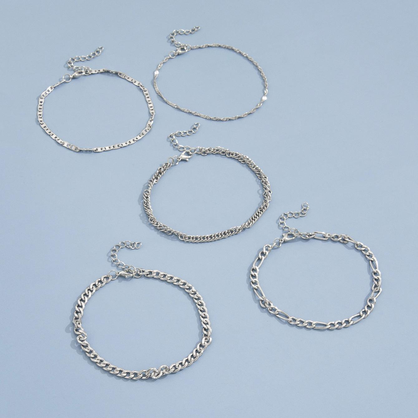 Stacked view of multiple snake chain anklets