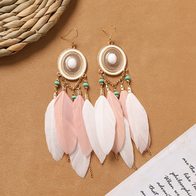 model wearing vintage style feather earrings