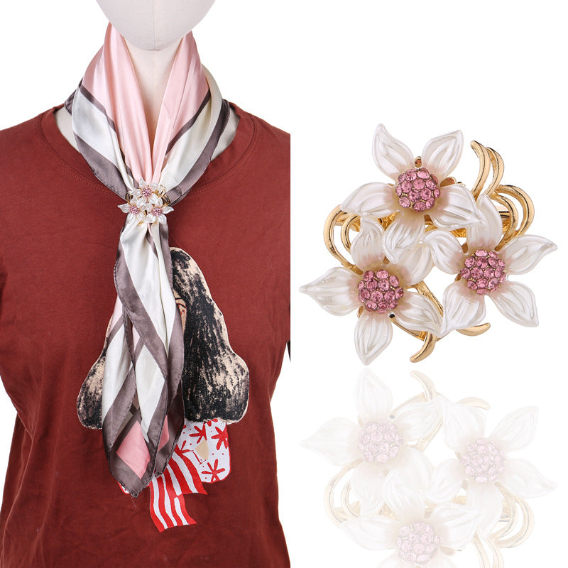 Floral rhinestone brooch on fabric