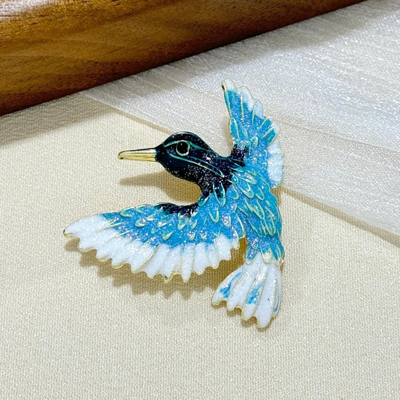 Close-up of blue wing bird detail on brooch