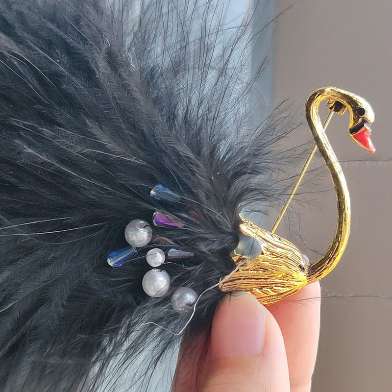 Detailed view of pearl accent animal brooch