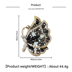 Alloy butterfly brooch on a plain background
