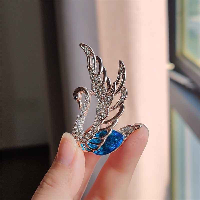 Swan Brooch featured as a trendy outfit accessory