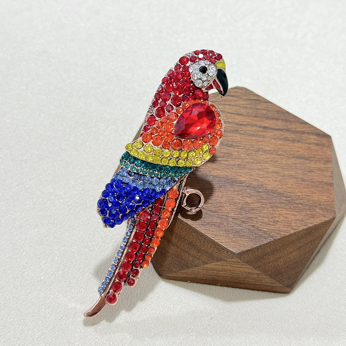 Elegant vintage parrot brooch on fabric