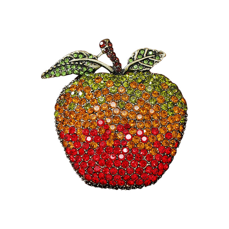 Vibrant apple design brooch on a colourful background