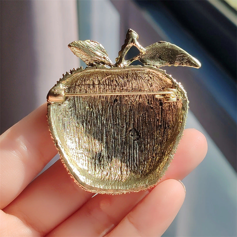 Fashionable fruit brooch against a stylish outfit