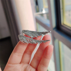 Vintage angel wings brooch attached to a jacket