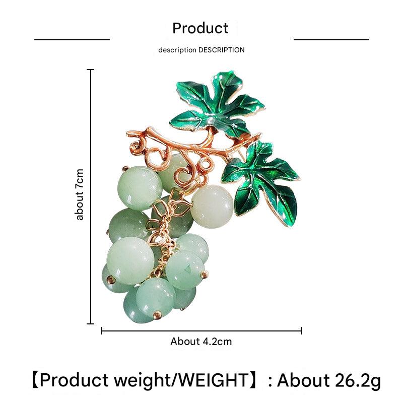 Vibrant fruit motif pin brooch on display