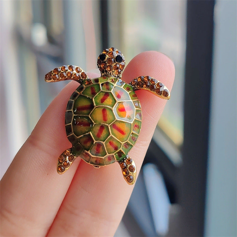 Glittery turtle brooch showcasing rhinestones