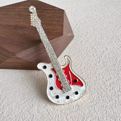 Guitar-shaped brooch with sparkling rhinestones