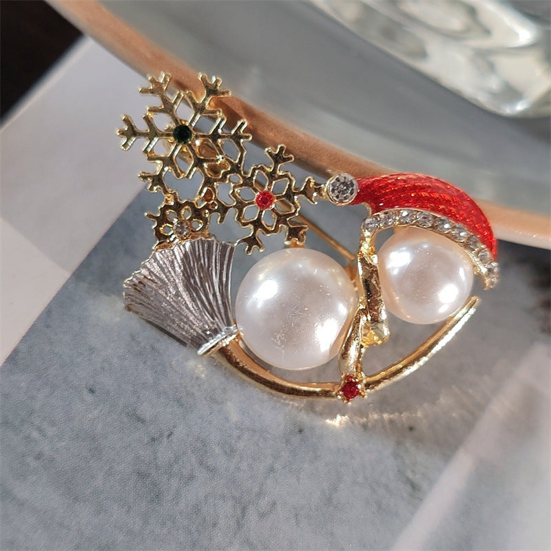 Snowman brooch on a snowy background