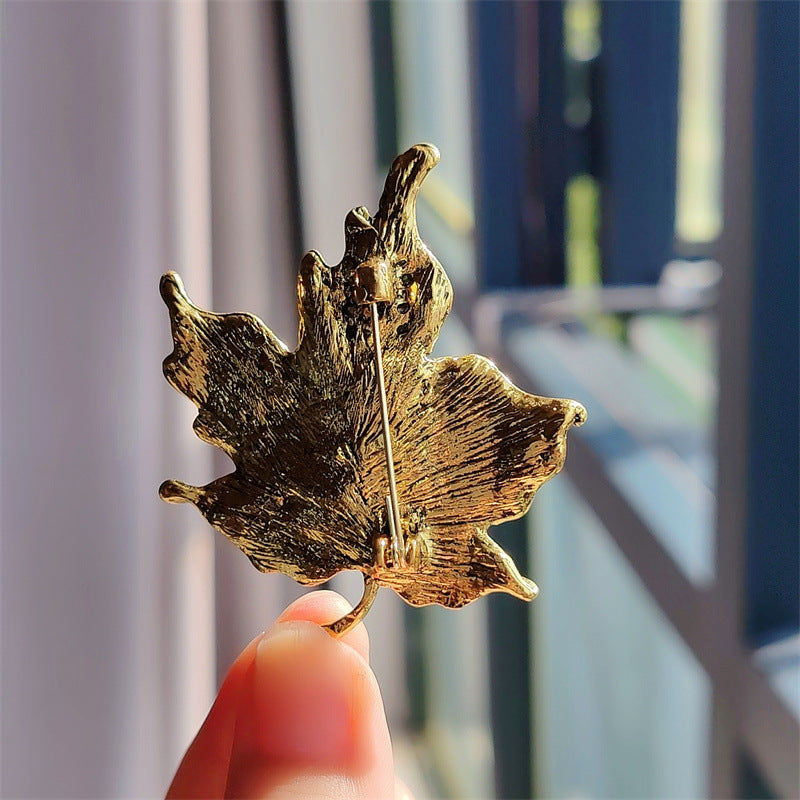 Stylish vintage leaf brooch with vibrant crystals