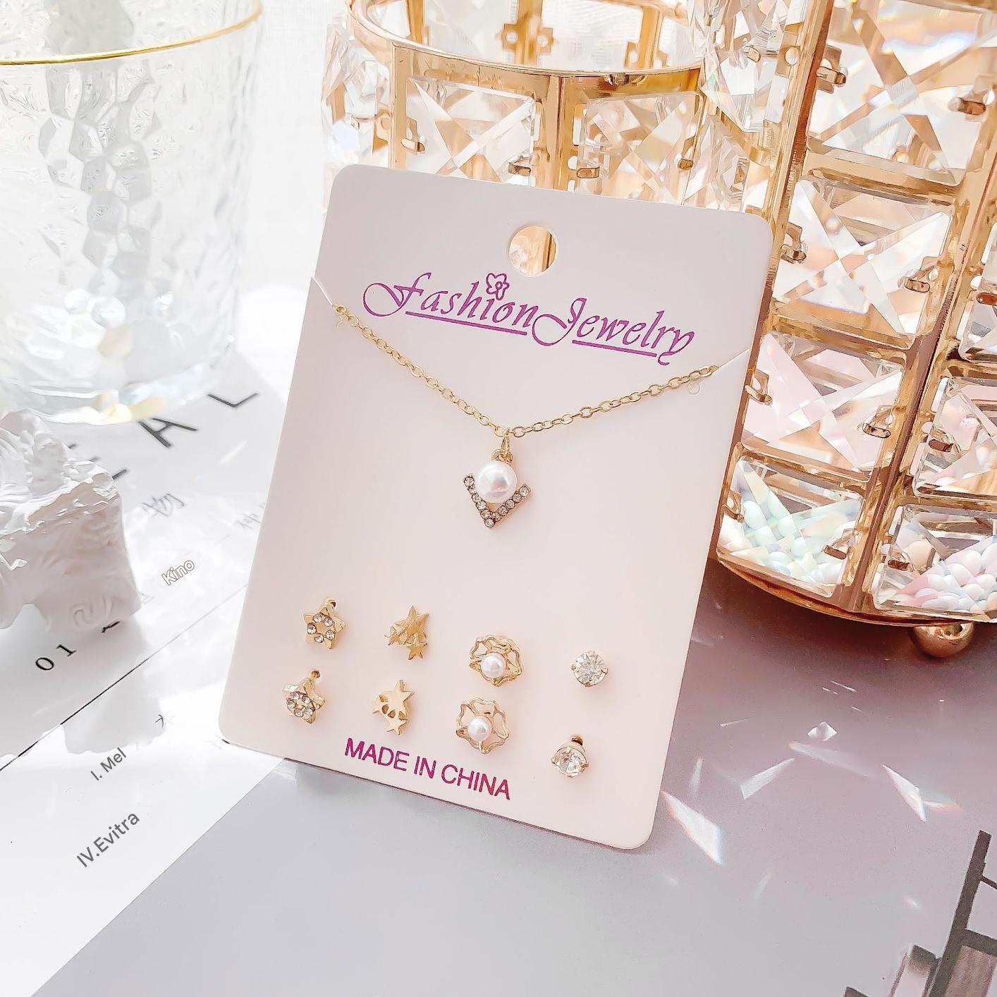 Playful moon and snowman themed earrings close-up