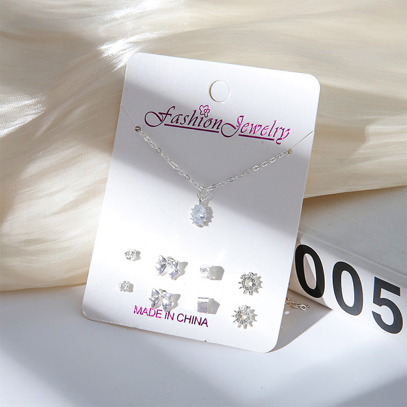 Set of minimalistic jewellery including necklace and earrings