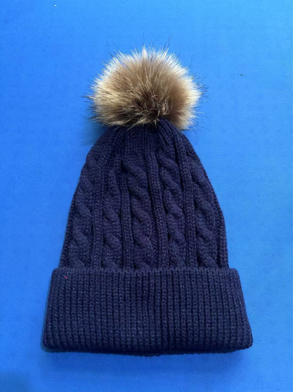 Pink knit beanie with pom pom details