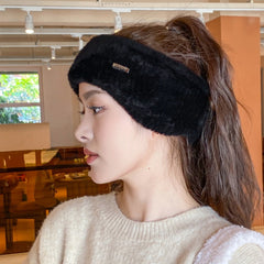 Pink winter beanie displayed in sporty wear