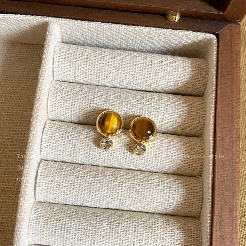 Model wearing vintage tiger eye earrings