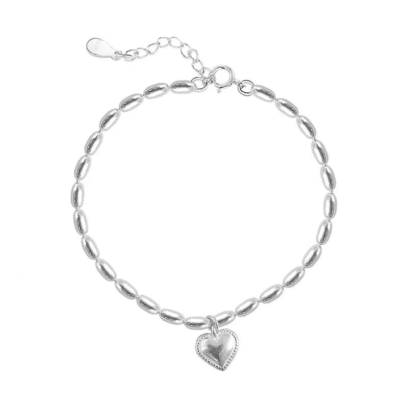 Versatile heart charm bracelet on a neutral background