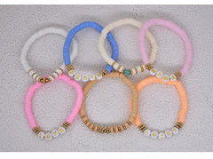 Various colours of polymer clay bracelets together
