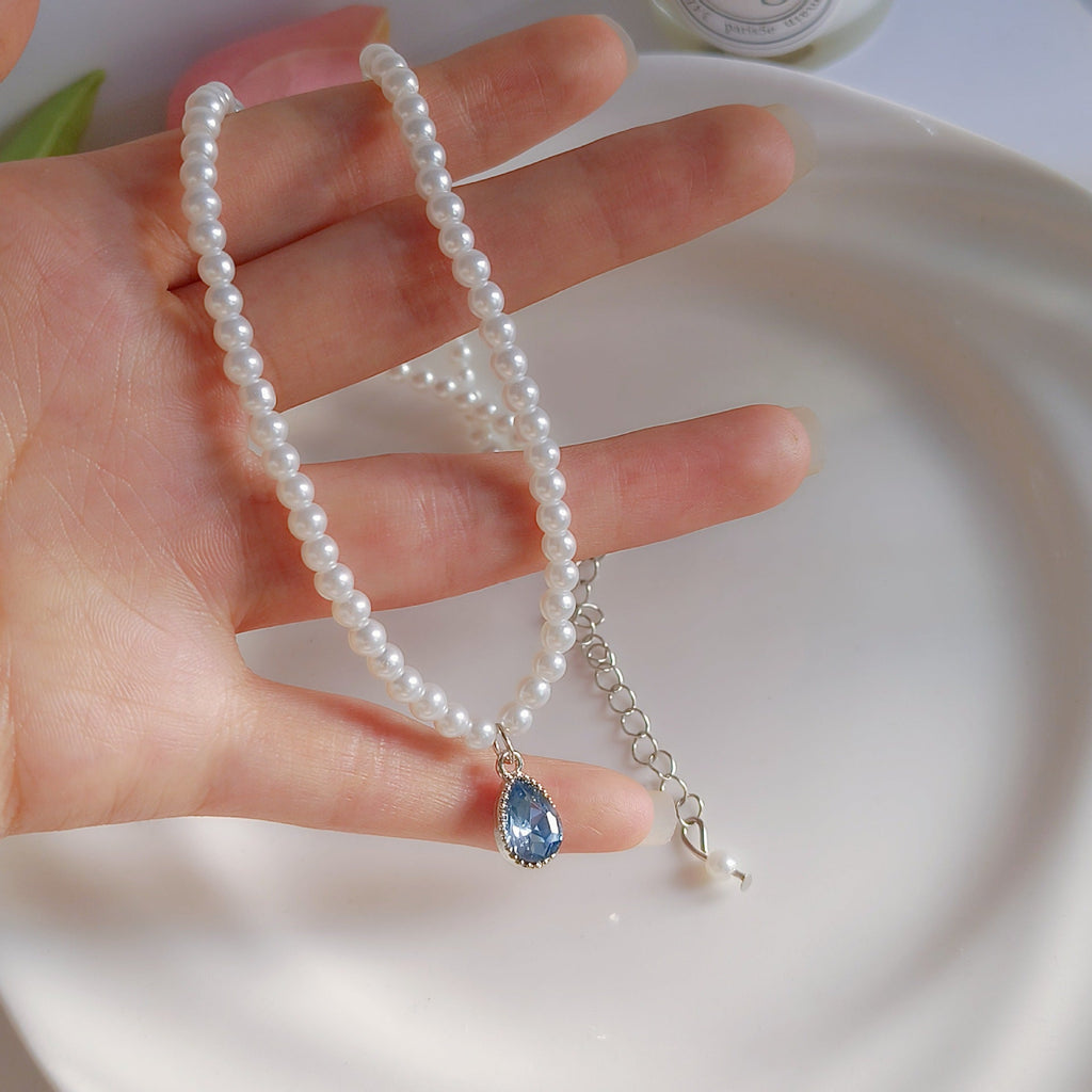 Luxury blue waterdrop pearl necklace being styled