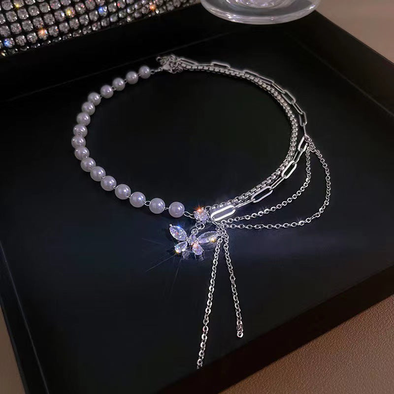 Close-up of butterfly pearl necklace with tassels