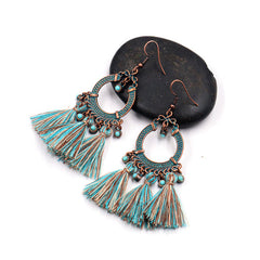 stylish earrings placed on a soft fabric background