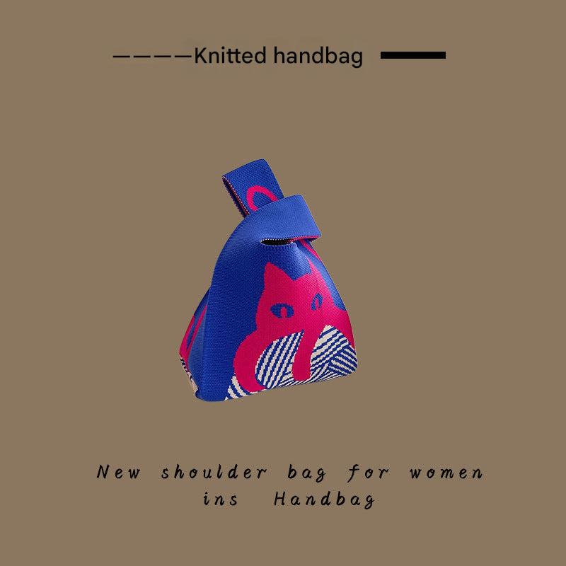 Women using a knitted tote bag outdoors