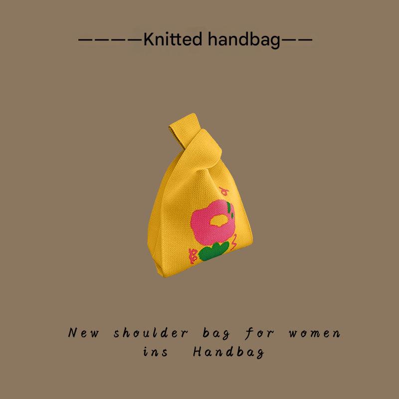 Women using a knitted tote bag outdoors