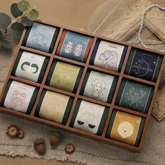 Various zodiac silk scarves arranged aesthetically